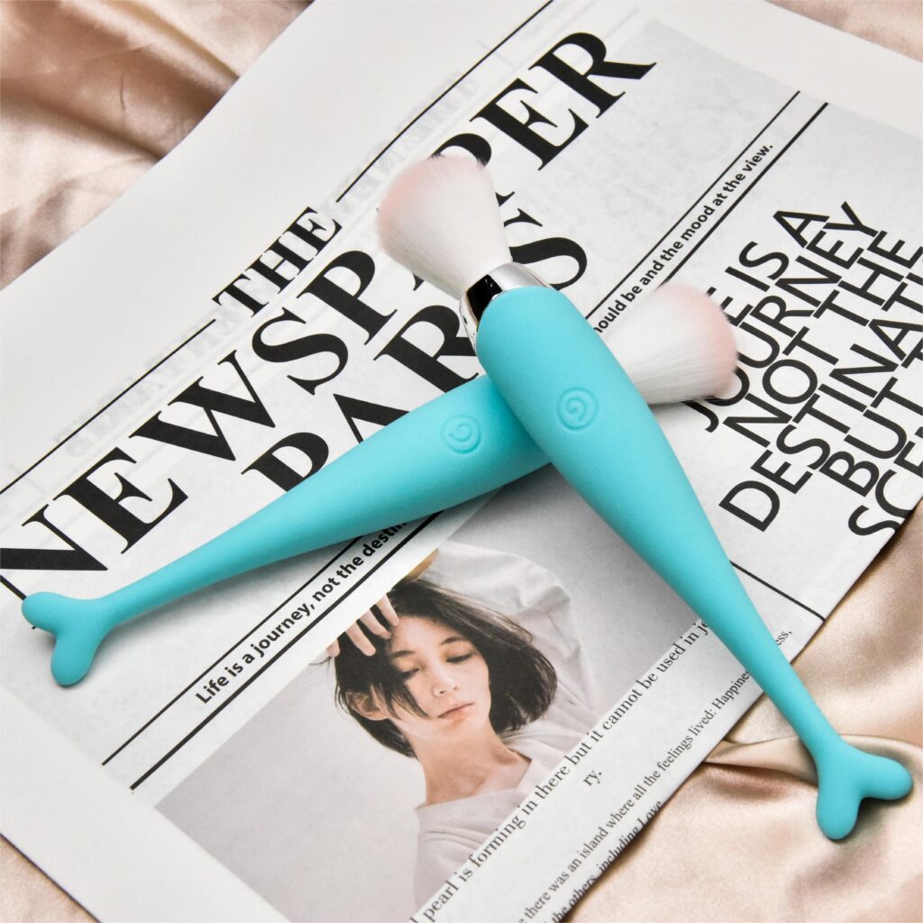 Two blue Beauty Brush Vibrator Sex Toys are placed crosswise on the newspaper.