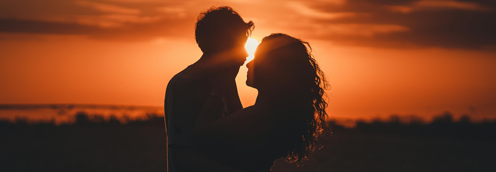 A couple hugging at sunset